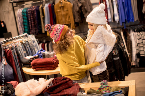 Two young women choosing winter clothes