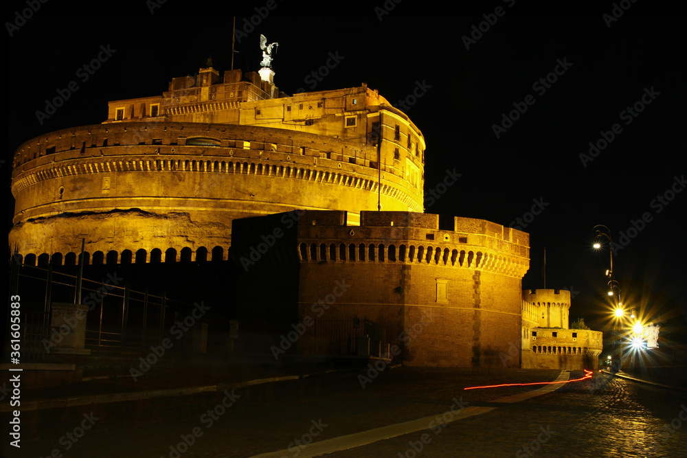 Sant'Angelo castel in Rome at night, side view, street lamps, black sky.