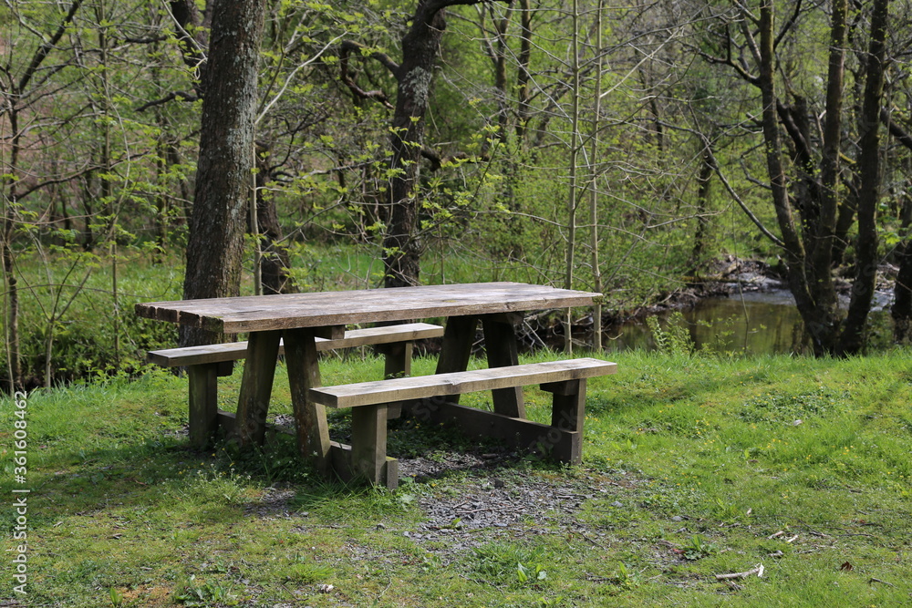 A picnic table beside the river Dulas in Wales, UK. A picnic table beside the river Dulas in Wales, UK.
