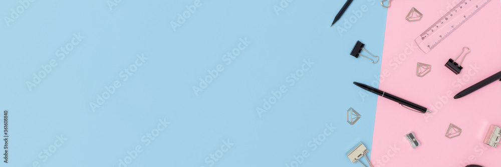 Banner with black office supplies on a pink and blue pastel background. Creative layout with copy space. Banner with black office supplies on a pink and blue pastel background. Creative layout with copy space.