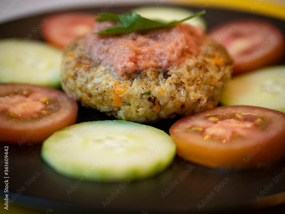 Vegan legume burger with fresh tomato and cucumber slices