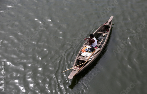 A Fishermen searching coins through magnet for his survival from river gomti in Lucknow ,according to the fishermen due to lockdown his earning is complitly colapse,so he is doing this work. photo