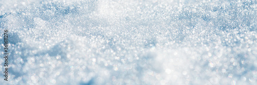 Snow surface close-up. Winter background with snow texture and beautiful bokeh. Shallow depth of field and blur. Perfect for Christmas and New Year design. View with copy space. © Andrei Stepanov