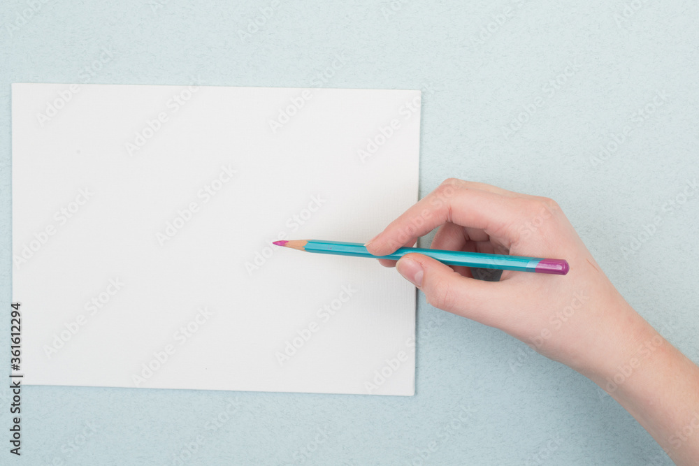 pencil in hand on a blue and white background pencil in hand on a blue and white background