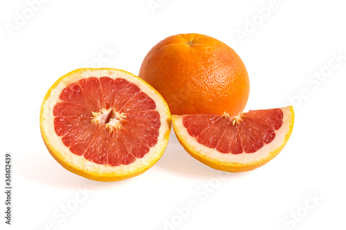 Ripe red whole and sliced grapefruit on white background. Minimal fruit concept.