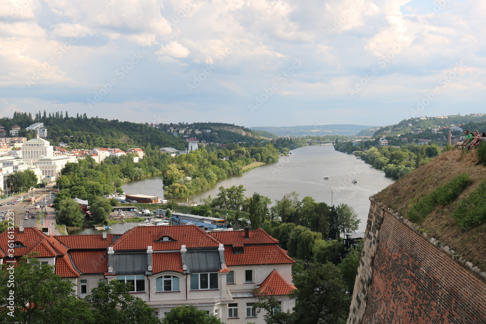 Panorama of Prague and the Vltava river on a hot, cloudy summer day