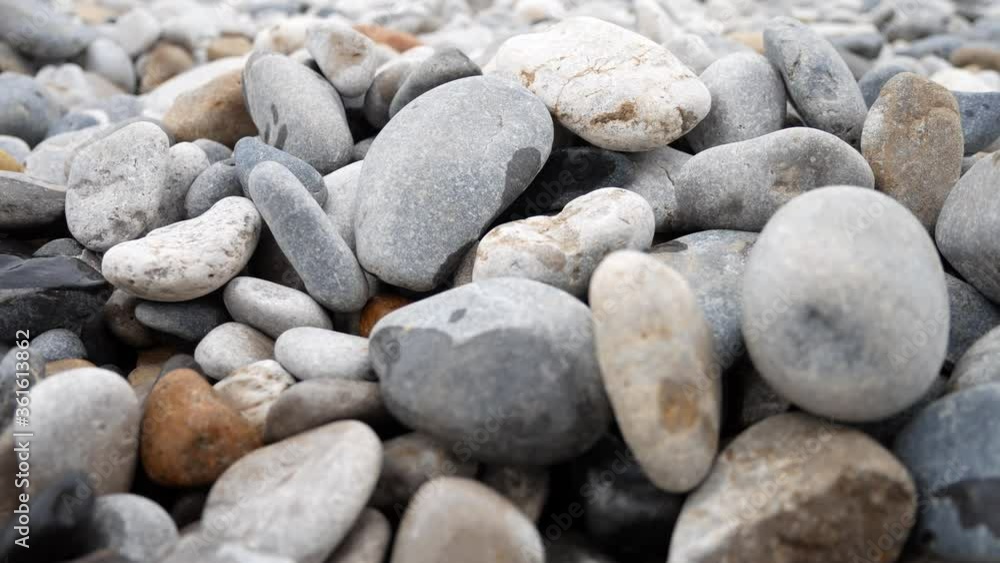 Round pebble beach grey texture stones closeup shallow focus dolly right Round pebble beach grey texture stones closeup shallow focus dolly right