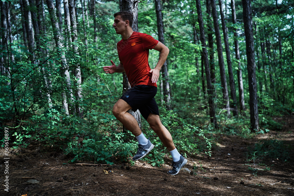 Young man running alone on an empty road