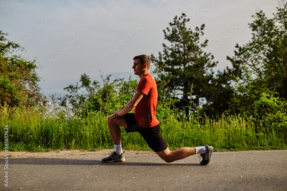 Young man running alone on an empty road Young man running alone on an empty road