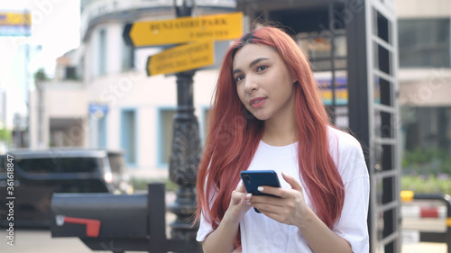 Independent concept. Indie women are playing phones in the city. 4k Resolution.
