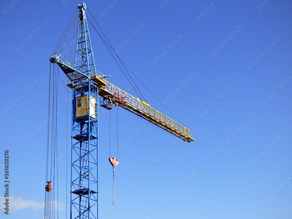 Industrial construction crane on blue sky. Industrial construction crane on blue sky.