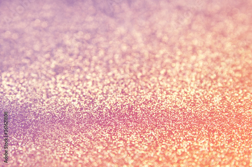 Pink Gold glitter texture sparkling paper background. Abstract twinkled glittering background with bokeh, defocused lights for Christmas holiday, banner, wedding invitation and greeting cards.