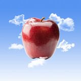 Red Apple with Clouds and a Blue Sky Background