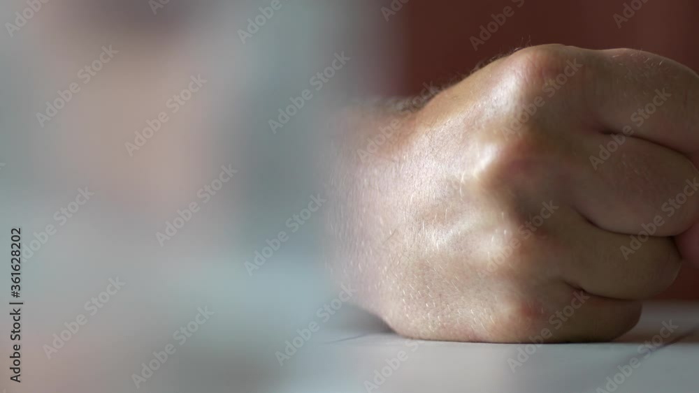 Man strikes fist on table in anger. Domestic violence. Close up. Slow pan. Man strikes fist on table in anger. Domestic violence. Close up. Slow pan.