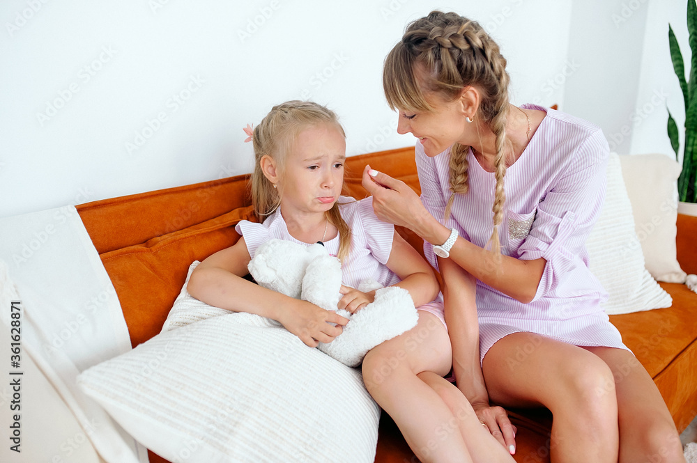 The problem of misunderstanding, the offended child, the concept of education, the behavior of the child, the daughter is pouting not paying attention to mom’s attempts to hug and calm The problem of misunderstanding, the offended child, the concept of education, the behavior of the child, the daughter is pouting not paying attention to mom’s attempts to hug and calm