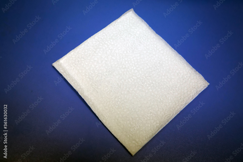 Blank paper napkin isolated on blue background with copy space . White napkin on blue background, many views of white napkins, blank mockup files .White Square Bar Napkin Isolated on blue Background . Blank paper napkin isolated on blue background with copy space . White napkin on blue background, many views of white napkins, blank mockup files .White Square Bar Napkin Isolated on blue Background .