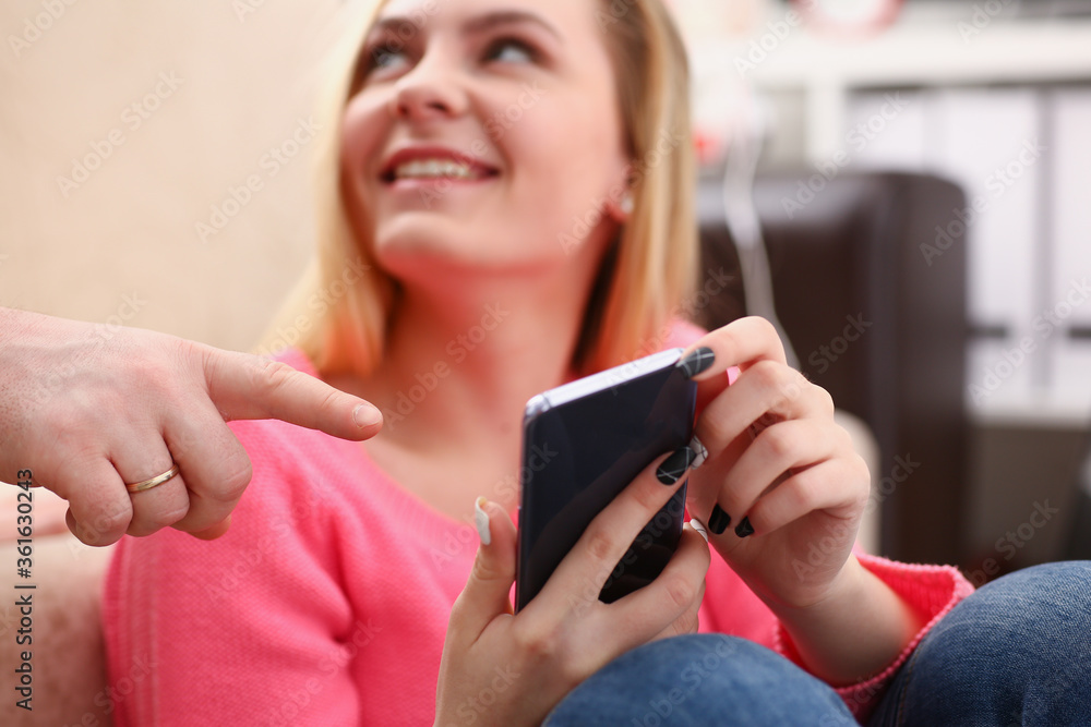 young pretty blond womansit on sofa hold smartphone in hands chat with friends young pretty blond womansit on sofa hold smartphone in hands chat with friends