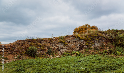 Ruined wall and the lawn of the medieval fortress Koporye