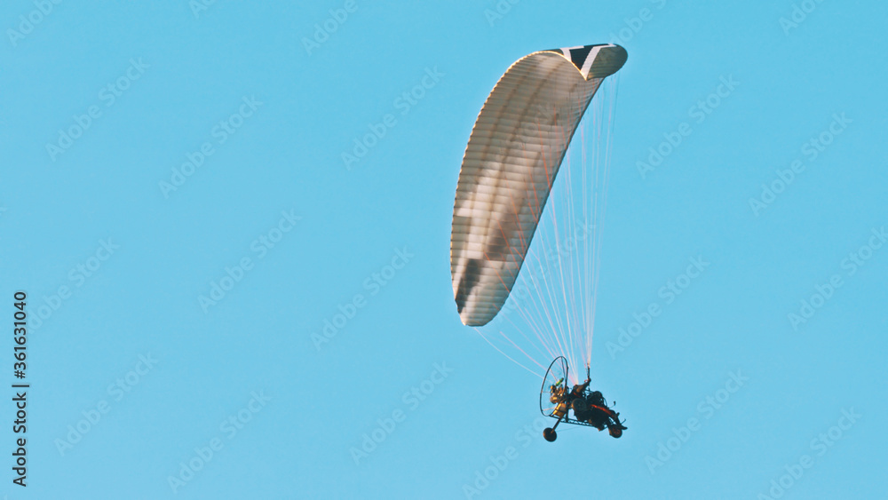 Paramotor Tandem Gliding And Flying In The Air. Copy space. High quality photo Paramotor Tandem Gliding And Flying In The Air. Copy space. High quality photo