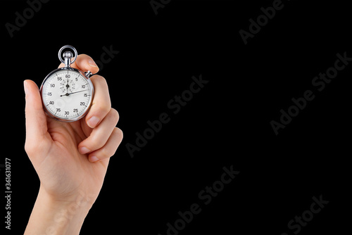 stopwatch hold in hand, button pressed, black back ground