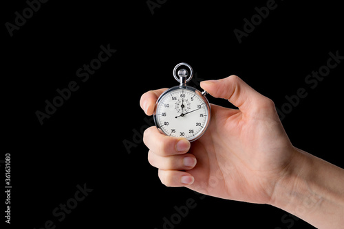 stopwatch hold in hand, button pressed, black back ground