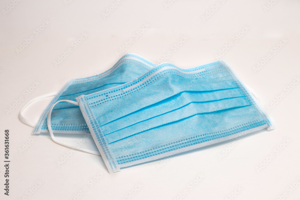 Fototapeta premium Covid-19 protective Medical mask, disposable surgical medical protective face mask covers the mouth and nose. Healthcare and Medical Concept white background.