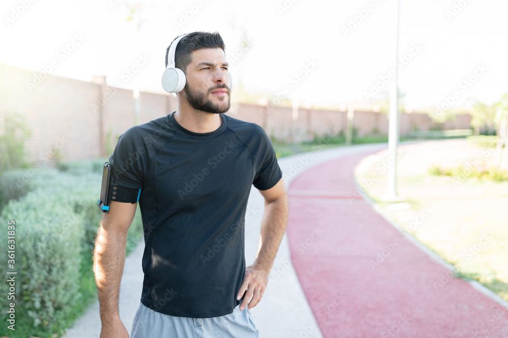 Man Listening Music While Working Out In Park