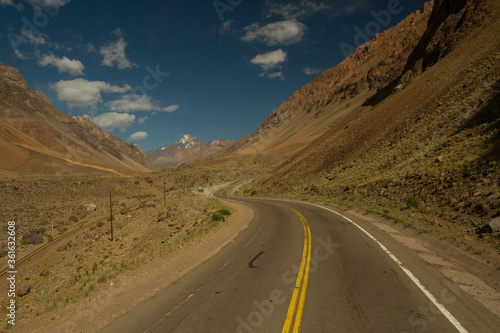 Adventure. Curve. Traveling along the empty asphalt road across the mountains and valley.