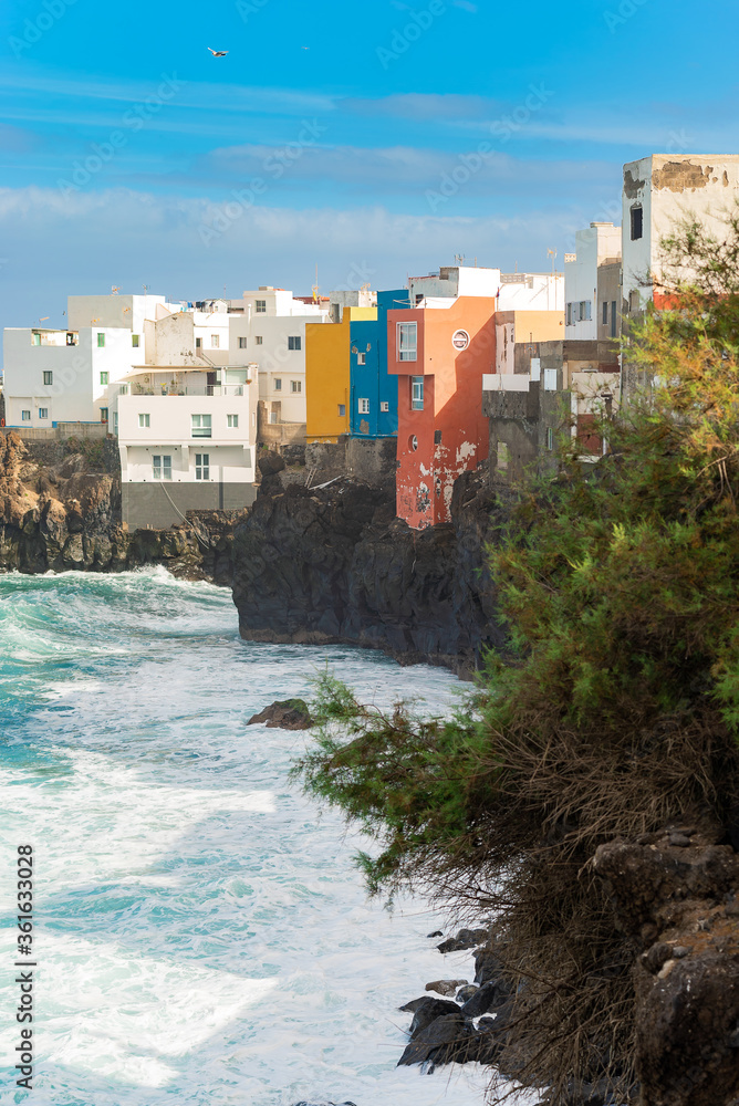 View on colorful buildings on the rock over the ocean in Punta Brava, Puerto de la Cruz, Tenerife, Canary Islands, Spain