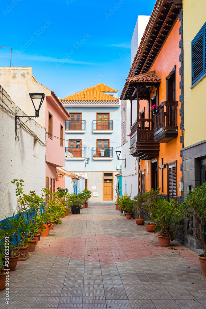 Colorful buildings on a narrow street in spanish town Punto Brava on a sunny day, Tenerife, Canary islands, Spain.