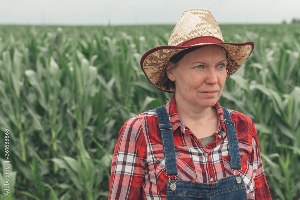 Portrait of female farmer standing in corn field