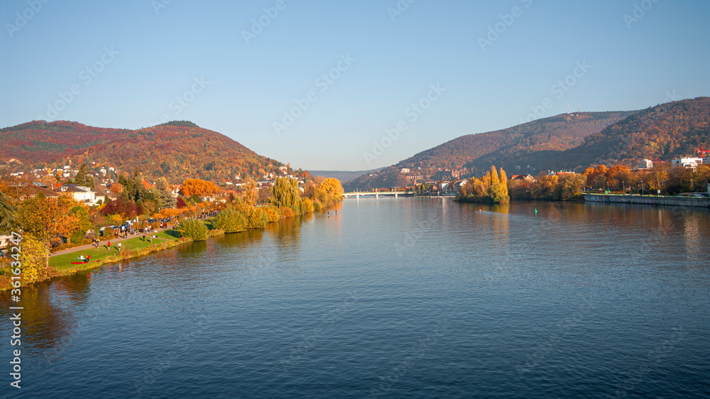 Panoramic view over stunning reddish sunset over the old town, castle and city bridges in Heidelberg during golden Autumn, Germany, fall