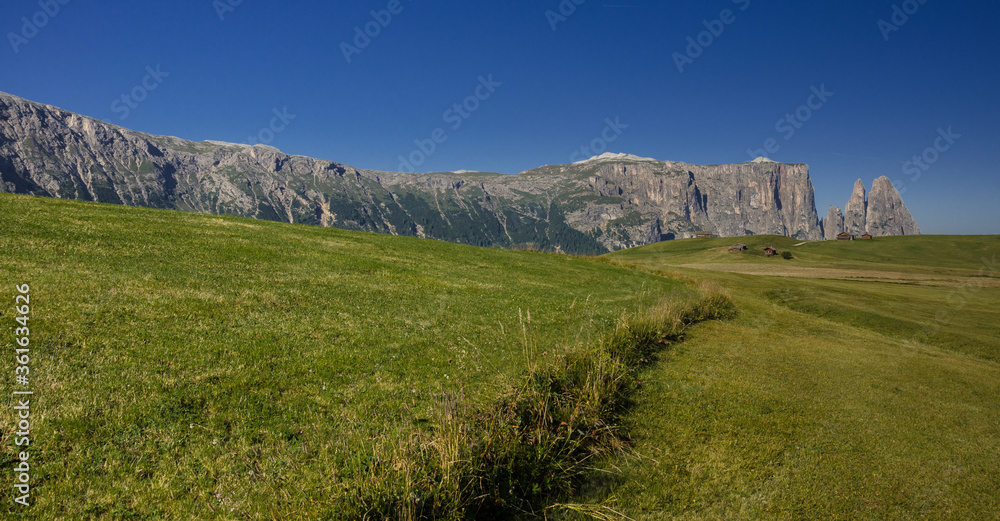 Sciliar mountain with Santner peak at its north west end as seen in the morning from Alpe di Siusi/Seiser Alm high plateau, on the trail over Denti di Terrarossa range, Dolomites, South Tyrol, Italy.