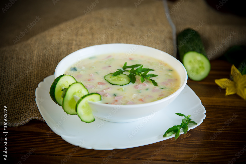 summer cucumber soup with vegetables on a wooden table summer cucumber soup with vegetables on a wooden table