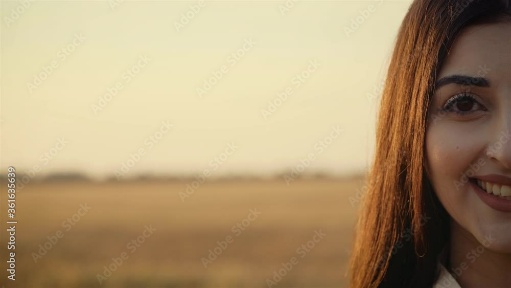Close up portrait of half woman face smiling at sunset. Happy and successful lifestyle concept Close up portrait of half woman face smiling at sunset. Happy and successful lifestyle concept
