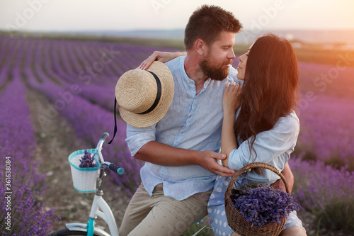 happy couple in laveder field. man and woman in sunset light in blooming lavender photo