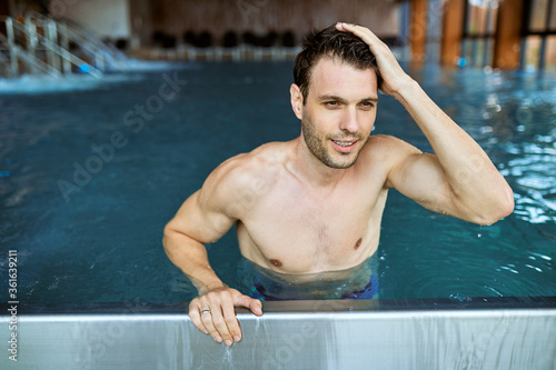 Smiling mid adult man enjoying in a weekend at the spa. © Drazen