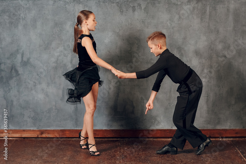 Young boy and girl dancing ballroom dance Jive