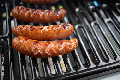 sausage grilled on a gas grill in closeup