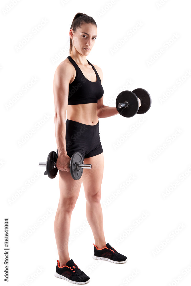 Young athletic woman working out with dumbbells Young athletic woman working out with dumbbells