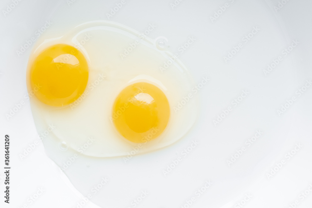 Two yolks in one chicken egg. Identical twins. Double egg. Two yolks in one chicken egg. Identical twins. Double egg.