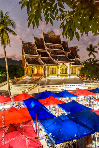 Wat Mai Suwannaphumaham often called Wat Mai or Wat May is a Buddhist temple  in Luang Prabang Laos with the Blue and Red Tents for the Night Market  © Mark