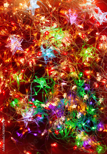 Lights decoration. Red background with Christmas multi-colored lights garland.