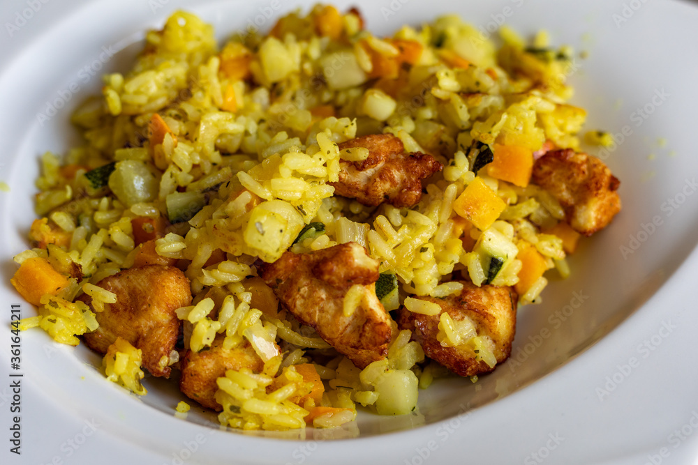 paella with meat, pepper, vegetables and spices on dish paella with meat, pepper, vegetables and spices on dish