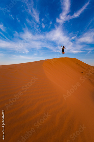 Happy woman on Red sand dunes in Vietnam
