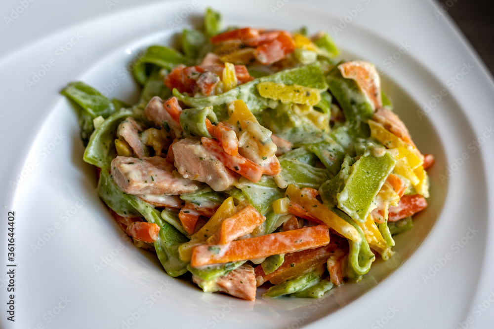 Salmon and Spinach Fettuccine pasta on white dish Salmon and Spinach Fettuccine pasta on white dish