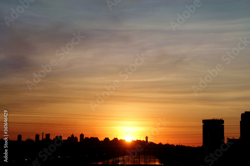 City skyline with sunset in the background © Stela