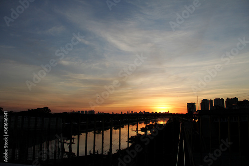 City silhouette with sunset reflected in the river