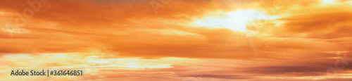 Summer sunset dranatic sky panorama with fleese clouds. Summer evening sky and weather concept background.