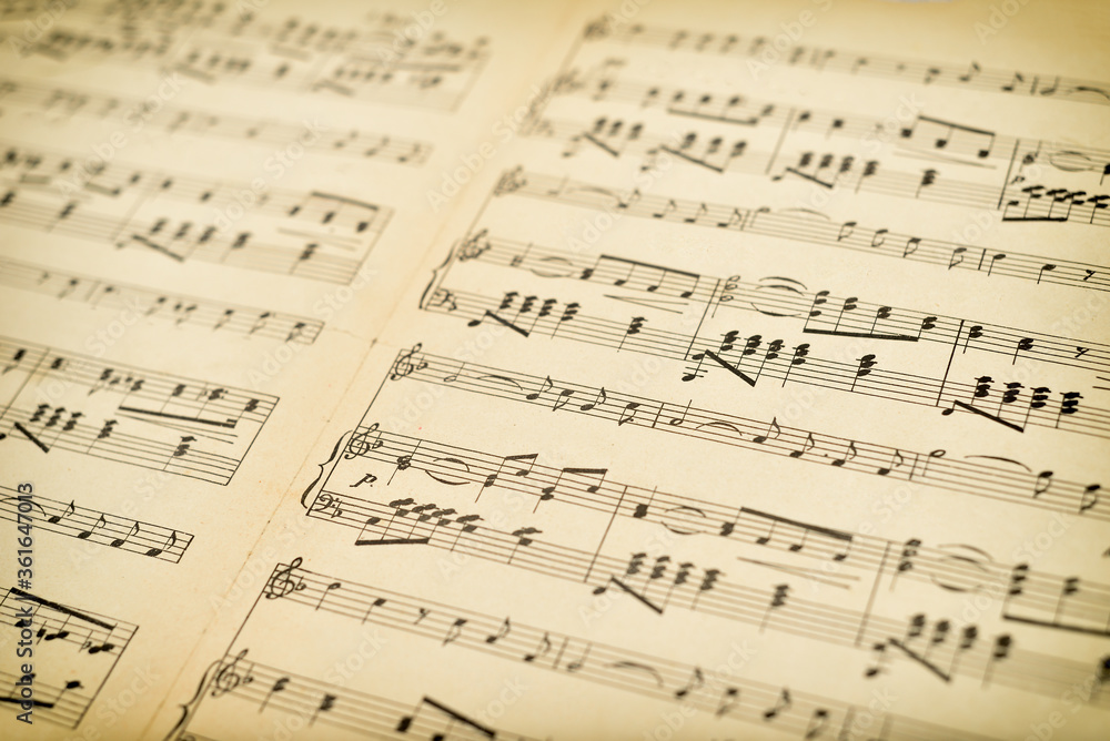 Fragment of old grunge sheet with music notes. Close-up. Retro style. Selective focus. Fragment of old grunge sheet with music notes. Close-up. Retro style. Selective focus.